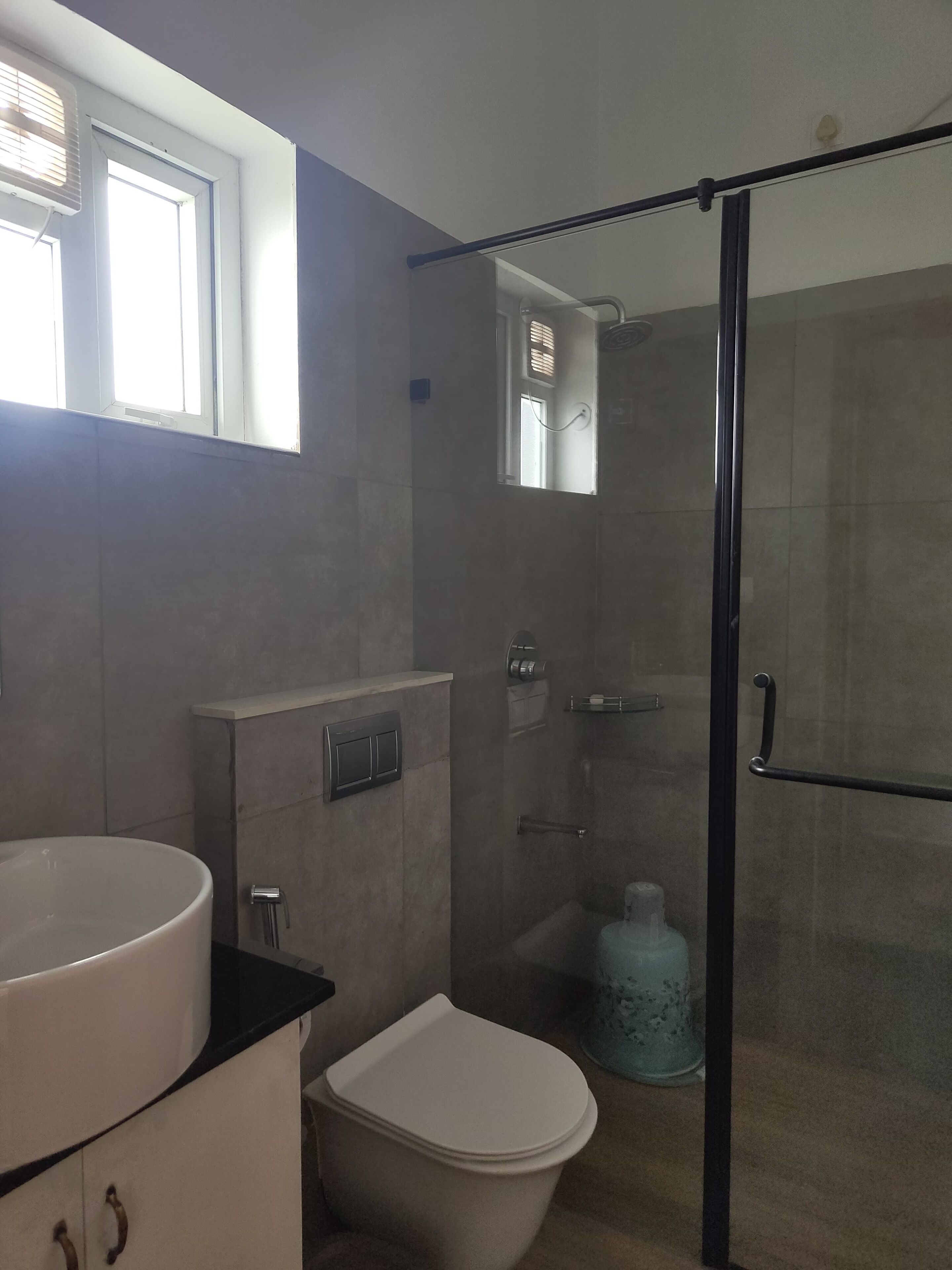 A bathroom with a toilet, sink, and shower.