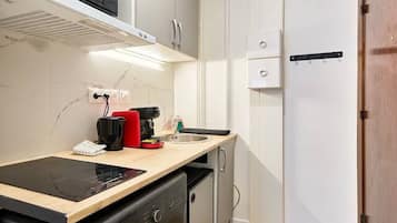 Fridge, microwave, coffee/tea maker, cookware/dishes/utensils