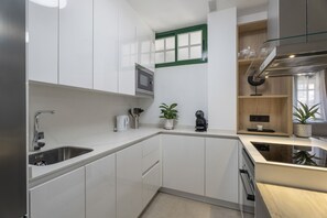 Fridge, microwave, coffee/tea maker, cookware/dishes/utensils
