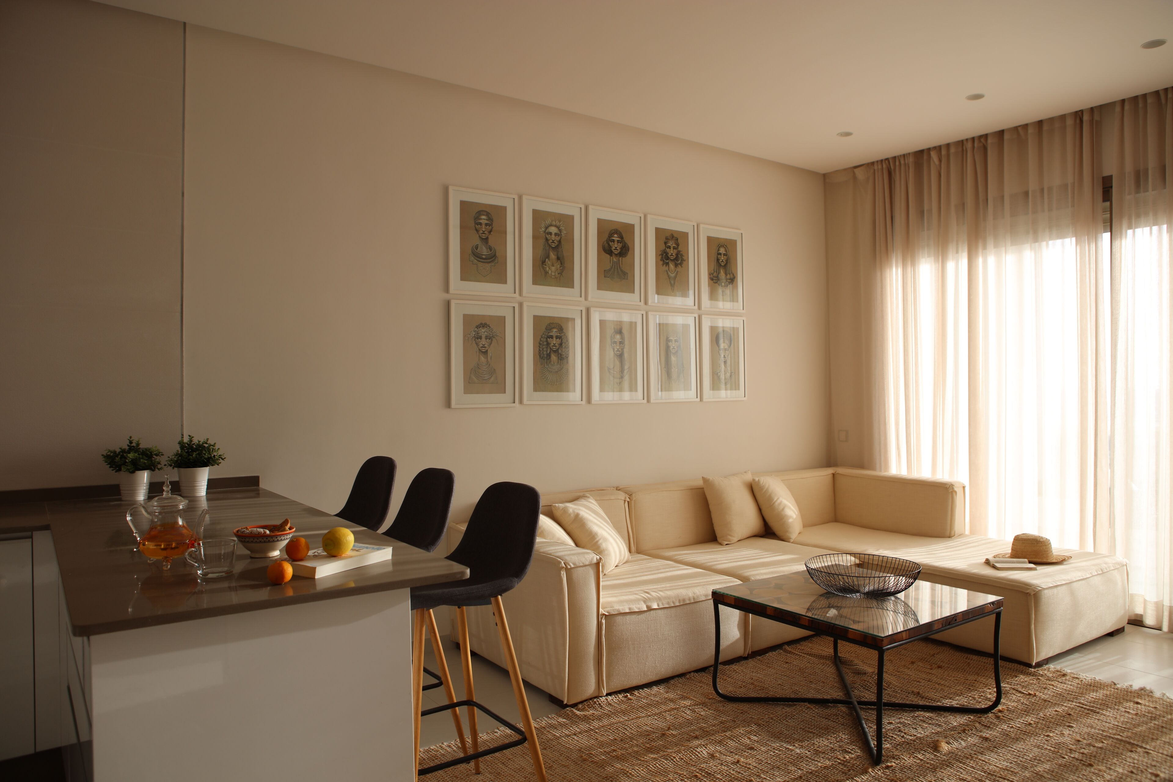 A modern living room with a sofa, chairs, a coffee table, and artwork on the wall.