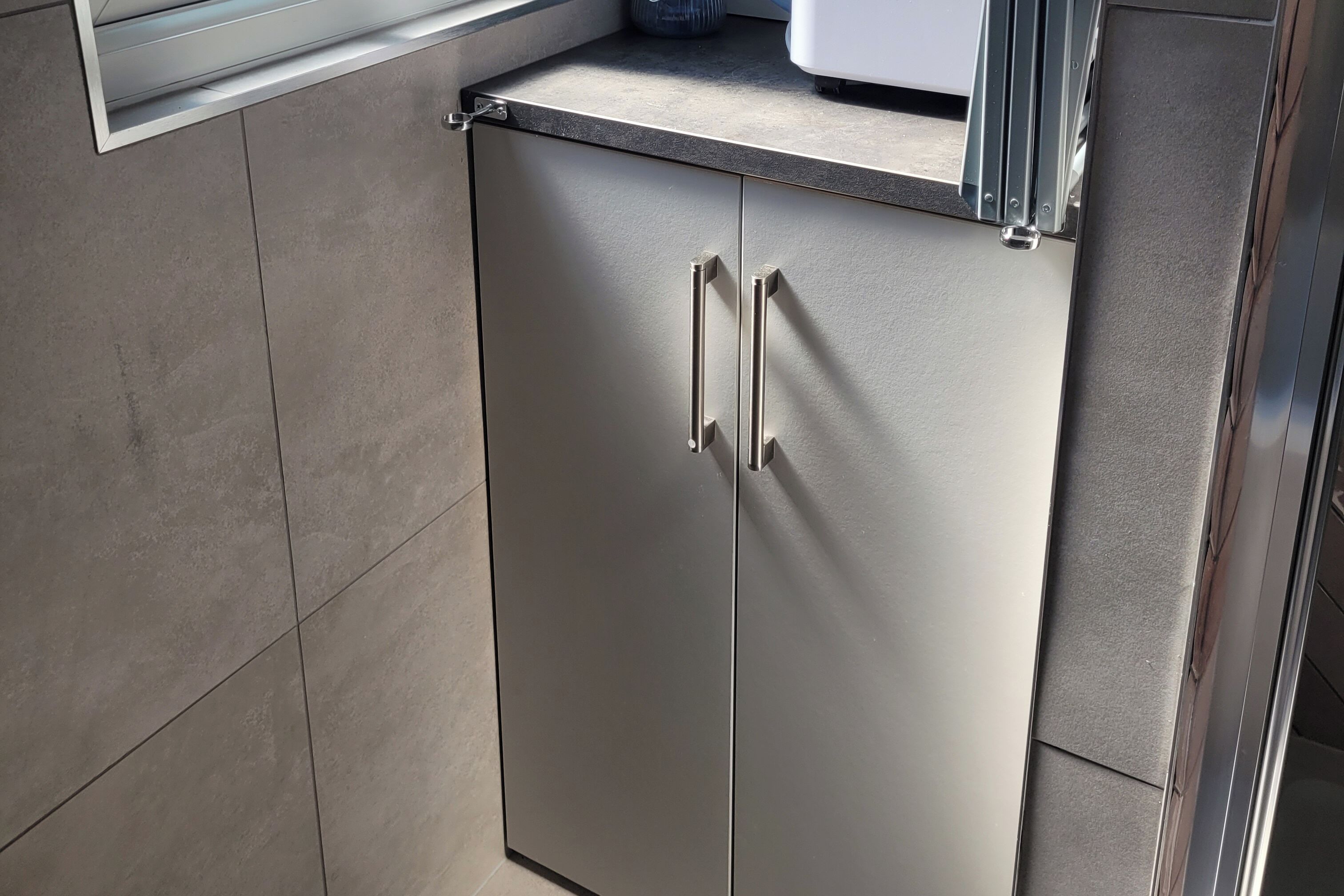 A modern kitchen with stainless steel cabinets and a countertop.