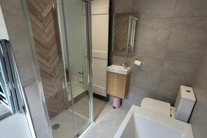 Separate bathtub and shower, deep-soaking bathtub, hair dryer, towels