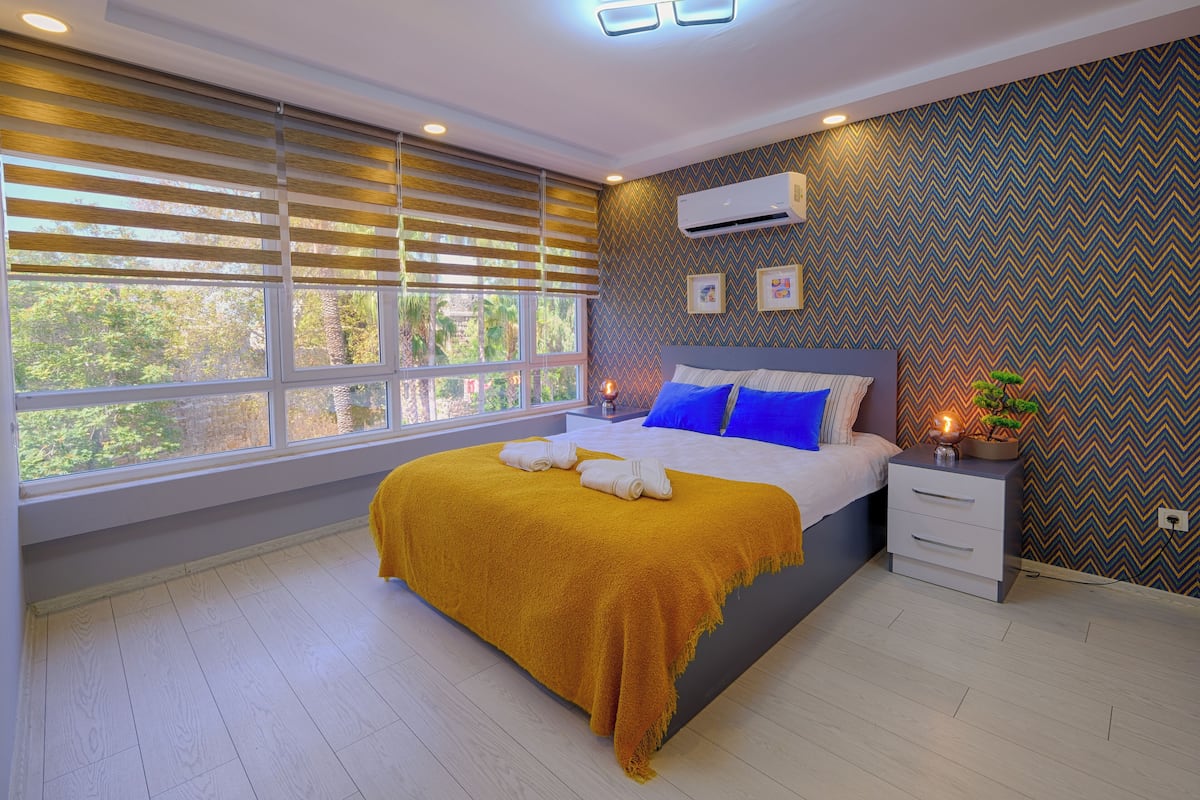Premium bedding, desk, laptop workspace, iron/ironing board