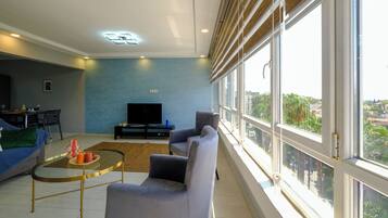 Apartamento panorámico, 1 cama de matrimonio con sofá cama, cocina, planta ejecutiva | Zona de estar | Smart TV de 43 pulgadas con canales por cable