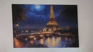 A bedroom with a large painting of the Eiffel Tower at night, a bed with two pillows, and a wall-mounted light fixture. - Colin's Suite at Hope Residences (Trece Martires)