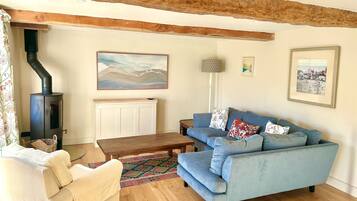The living room with log burner (logs included) and pop-up TV
