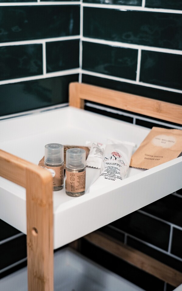 A bathroom with a wooden chair, a white countertop, and a tiled wall.