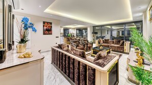 A modern living room with a sofa set, a coffee table, and a decorative plant. - Modern 4-bedroom villa • Private pool - 10 min from Kleopatra beach (Antalya)