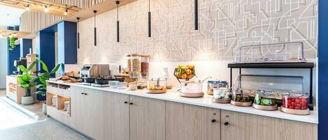 A modern breakfast bar with a variety of food options, including fruits, cereals, and pastries.