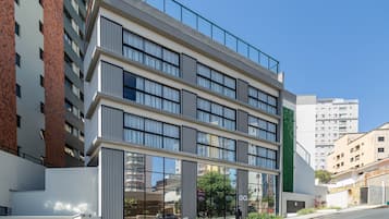 Un edificio de varios pisos con un diseño arquitectónico moderno, con amplias ventanas y techo plano.