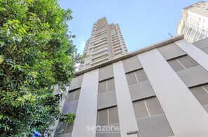 A modern building with a prominent vertical design, large windows, and a flat roof.