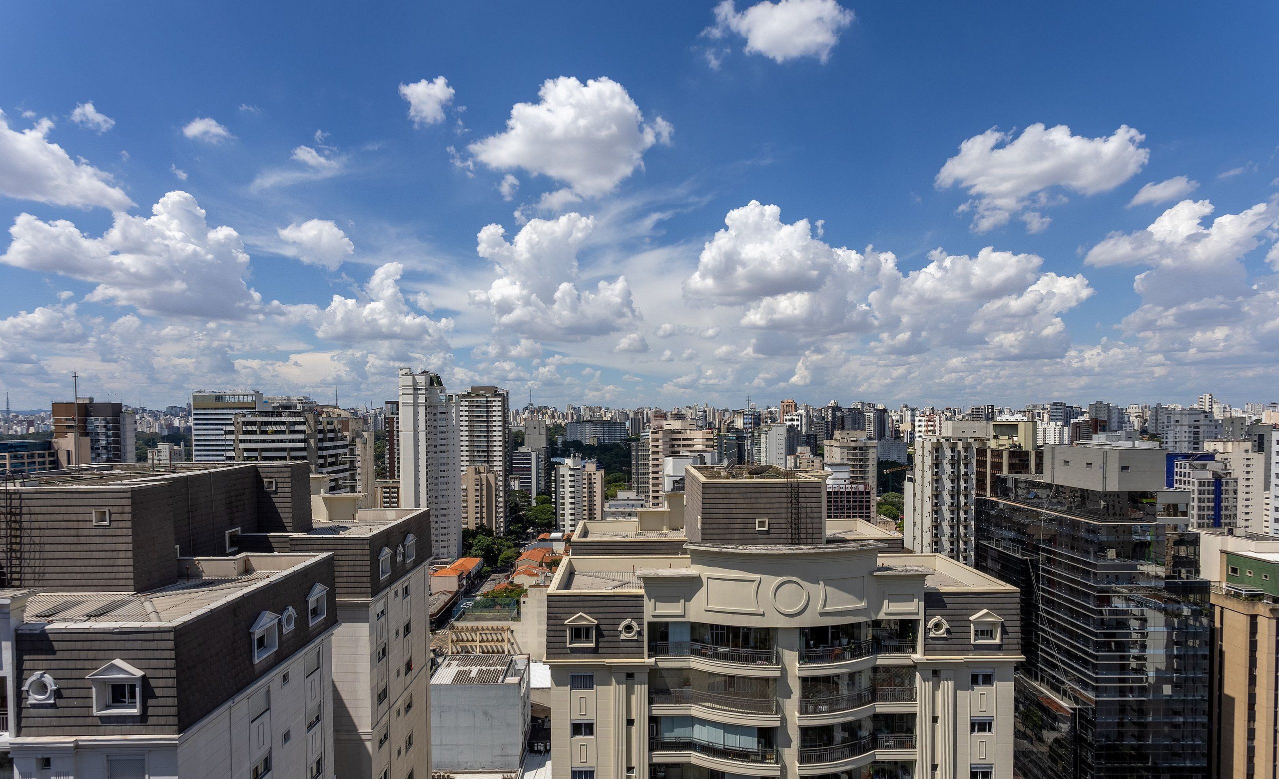 A high-rise building with multiple balconies and a modern architectural design.