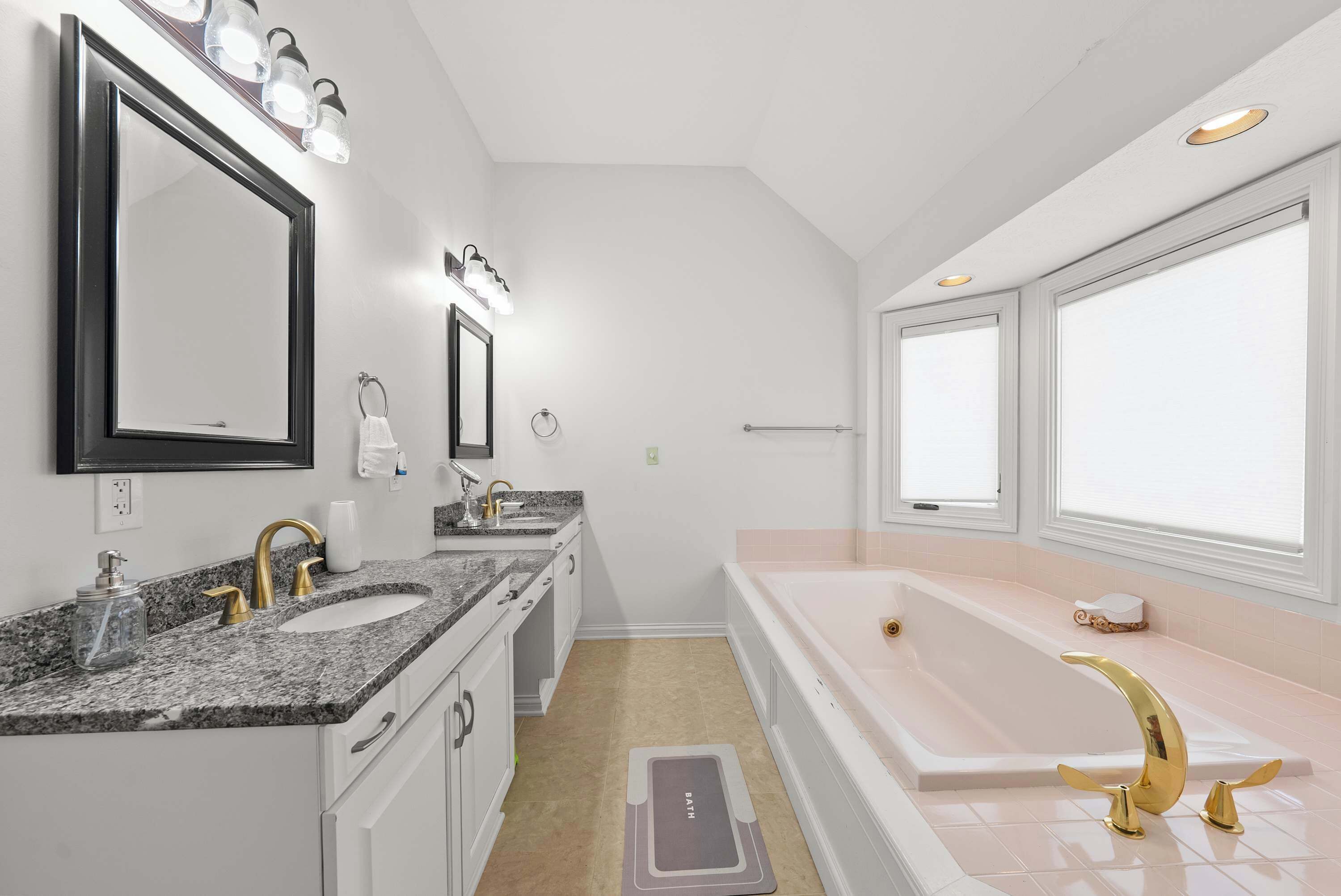 This king ensuite offers dual vanities, a soaking tub, & shower​