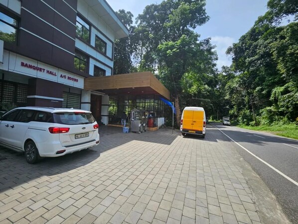 A building with a sign reading "BANQUET HALL A/C ROOMS". - Moon Way (Devikolam)