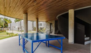 A ping pong table in an outdoor area with a wooden ceiling and stone walls. - House With Pool at Praia do Marceneiro Nluh0008 (Passo de Camaragibe)