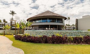 A resort with a circular building featuring a thatched roof, a pool area with lounge chairs, and a well-maintained garden with tropical plants. - House With Pool at Praia do Marceneiro Nluh0008 (Passo de Camaragibe)
