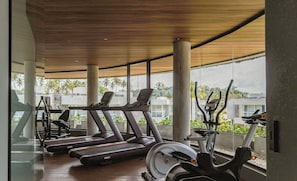 A gym with treadmills, elliptical machines, and a rowing machine, featuring large windows and a wooden ceiling. - House With Pool at Praia do Marceneiro Nluh0008 (Passo de Camaragibe)