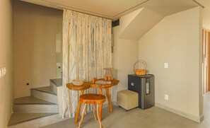 A staircase leading to a landing with a small table and chairs, a refrigerator, and a woven curtain. - House With Pool at Praia do Marceneiro Nluh0008 (Passo de Camaragibe)