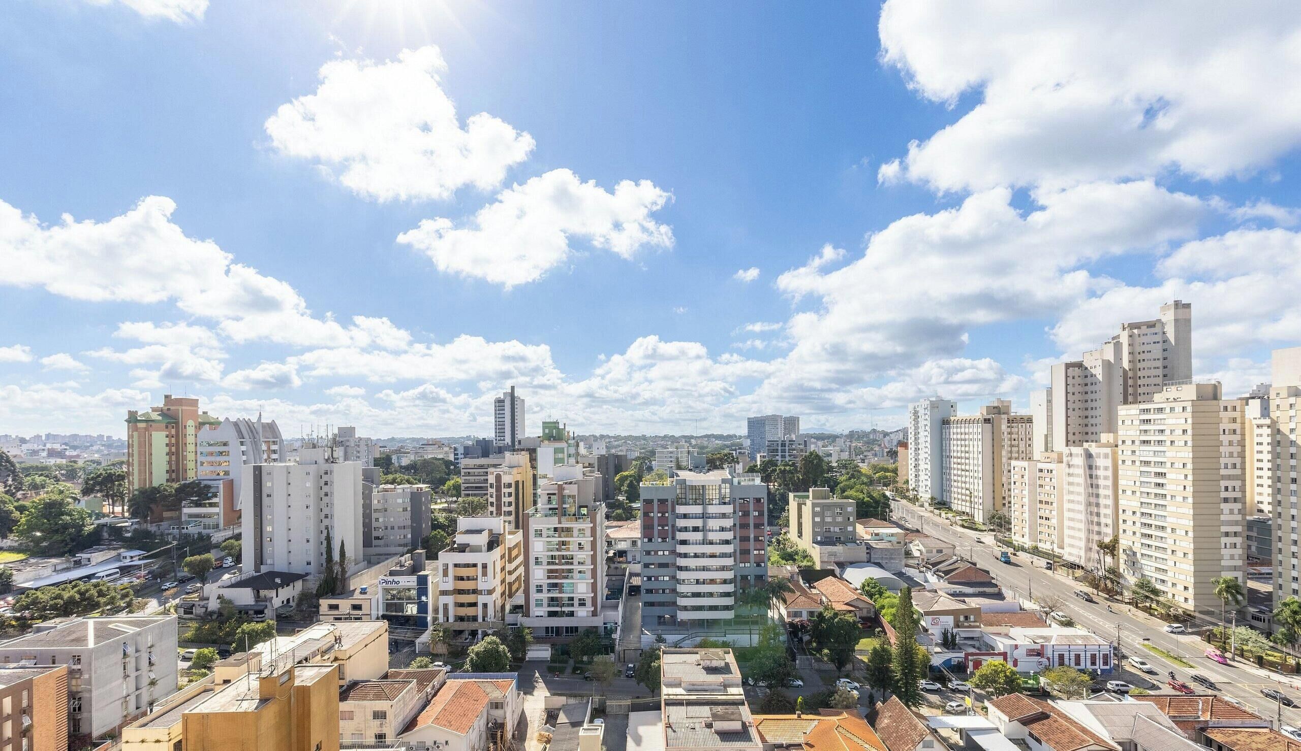A cityscape with various buildings, including high-rise apartments and smaller structures.