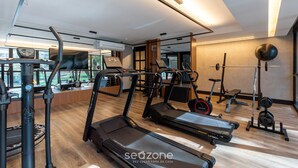 A modern gym with treadmills, a weight bench, and various exercise equipment. - Apt w/ Amazing View in Curitiba Nfe0708 (Curitiba)