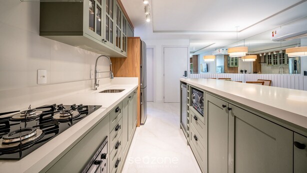 A modern kitchen with a central island, stainless steel appliances, and a large window. - Modern apt W/sea View in Porto Belo SC Mre801 (Porto Belo)