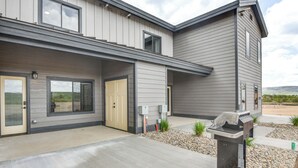 A modern two-story house with a covered patio and a barbecue grill. - Granby Ranch Escape: Shuttle to the Slopes! (Granby)