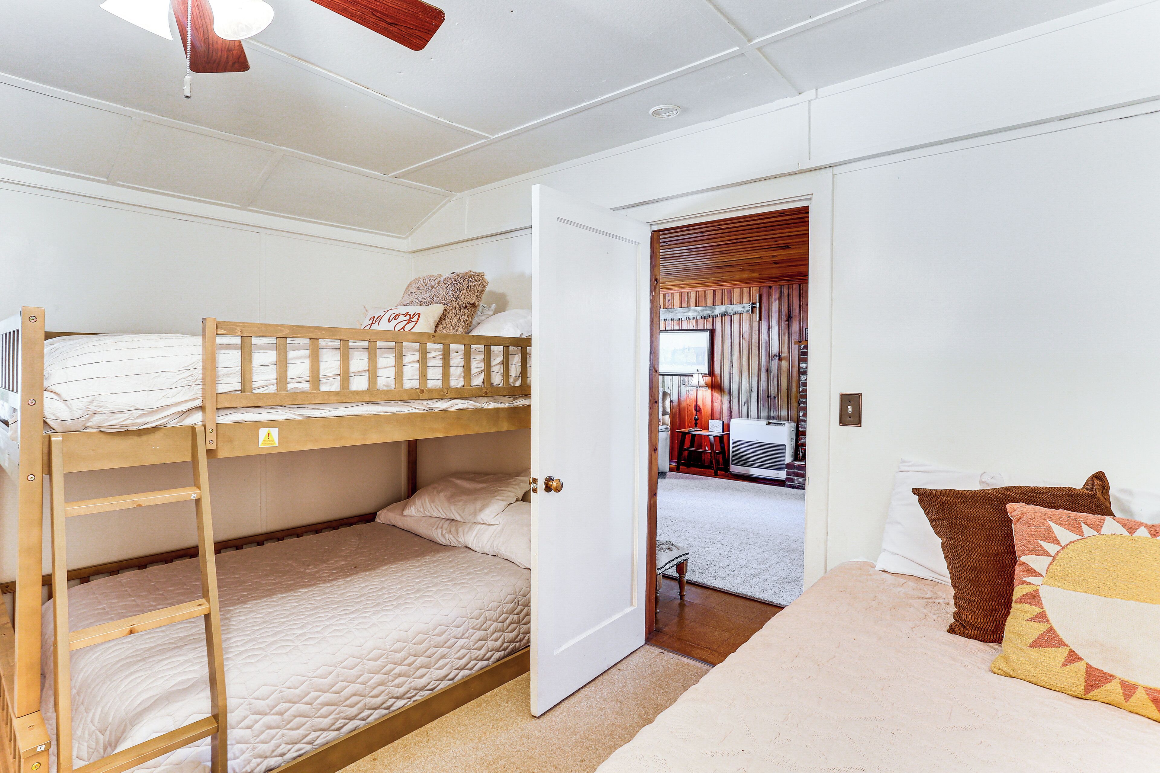 A bunk bed room with a door leading to a hallway.
