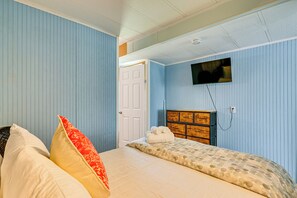 A bedroom with a bed, pillows, a dresser, and a television on the wall. - 3 Mi to Ft Myers Beach: Coastal Home Near Leetran! (Fort Myers Beach)
