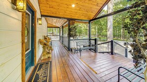 A wooden porch with a bench, a welcome mat, and a railing. - Hike, Fish & Unwind: Cabin w/ Yard in Broken Bow! (Broken Bow)