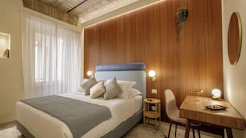 Deluxe Suite, 1 King Bed with Sofa bed, Kitchenette, Courtyard View | In-room safe, desk, laptop workspace, blackout drapes