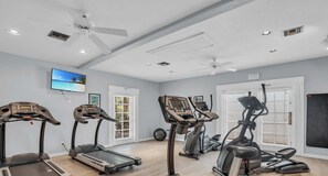 A home gym with treadmills, an elliptical, and a stationary bike.