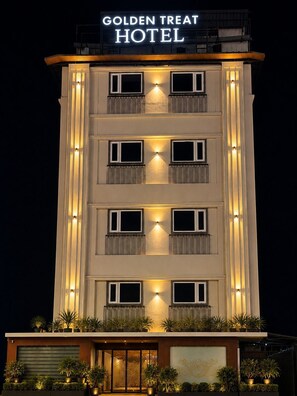 A multi-story hotel with a sign reading 'Golden Treat Hotel.' - Hotel Golden Treat (Indore)