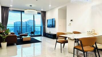 Deluxe Apartment, 3 Bedrooms, City View | Living area | 100-inch LED TV with cable channels