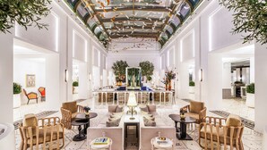 A spacious lobby with a central bar area, seating arrangements, and a patterned floor. - Fairmont Residences La Marina Rabat Sale (Sale)