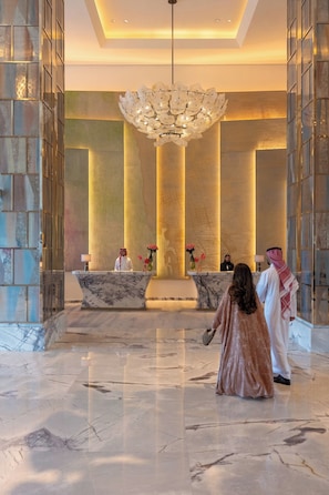 A lobby with marble floors, a reception desk, and a large chandelier. - Raffles Jeddah (Jeddah)