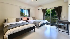 A modern bedroom with two beds, a desk, and a large window with curtains. - Riverside Chibana (Okinawa)