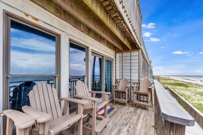 A wooden deck with Adirondack chairs overlooking a beach. - Ocean Mile G-1 Beach front, Pet Friendly, Community Pool! (St. George Island)