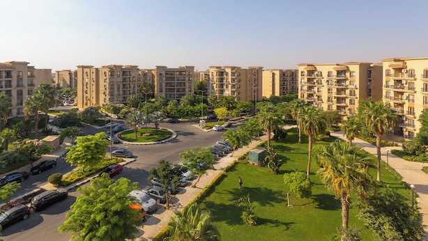 A residential complex with multiple apartment buildings, a central roundabout, and surrounding greenery. - Grand Stay Apartment in Rehab City (New Cairo)