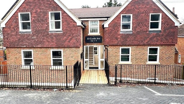 A two-story building with a brick facade, a sign reading "22 Castle Ave Apt 1-6", and a gated entrance. - Dover Ferry Luxury Apartments (Kent)