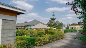 A residential area with houses, a paved driveway, and well-maintained hedges. - Katani Resort  (Mlolongo)