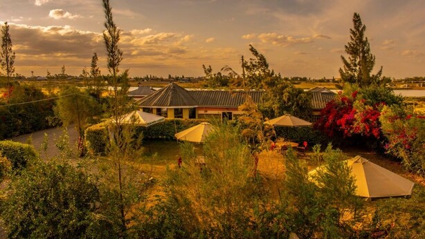 A resort with multiple tents and a building with a sloped roof. - Katani Resort  (Mlolongo)