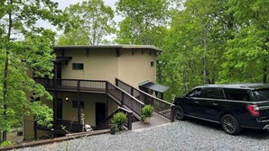 A two-story building with a balcony and a staircase.