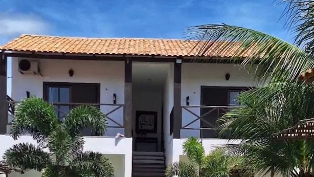 A two-story building with a swimming pool in front.