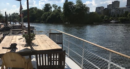 Houseboat on the Thames in London next to Kew Gardens