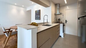 A modern kitchen with a central island, a sink, and a stove.