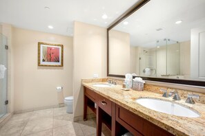 A modern bathroom with two sinks, a large mirror, and a framed artwork on the wall. - Honua Kai | Ocean View 4 BR, Sleeps 12 | Car Incl. w/ 6+ Nights | HKH ML-1574 by KBM (Lahaina)