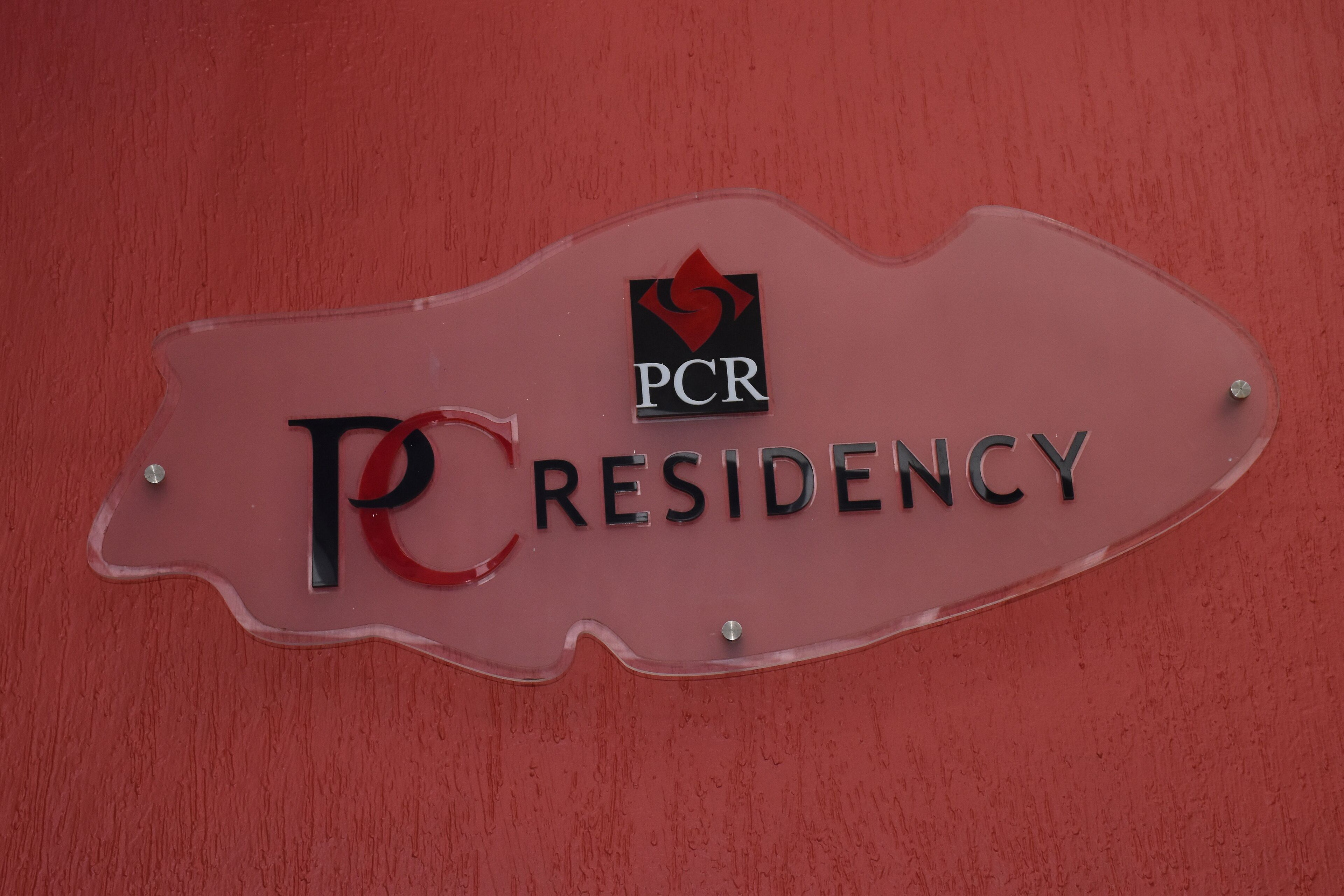 A sign with the text "PCR RESIDENCY" and a logo.