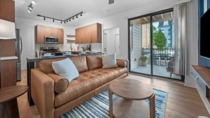 A modern apartment with a living room, kitchen, and balcony. - Immaculate Double King Suite | 4 beds | 2 Decks (Pittsburgh)