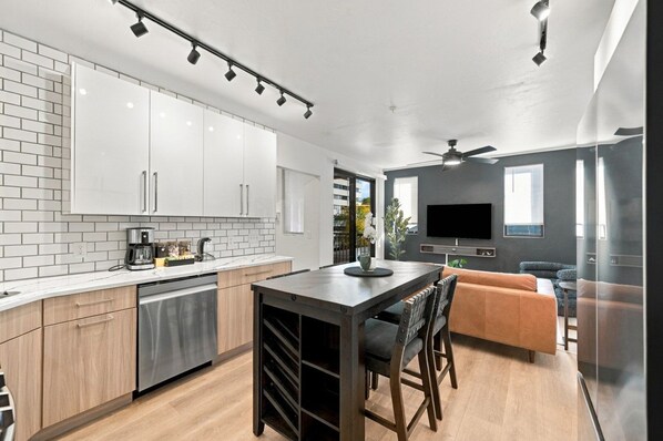 The kitchen flows seamlessly into the living area, creating an inviting open-concept space where everyone can stay connected while cooking, dining, or relaxing.