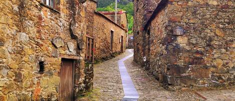 A narrow cobblestone street flanked by stone buildings with traditional architecture, a clear sky, and a date stamp indicating 2024/5/7 19:44.